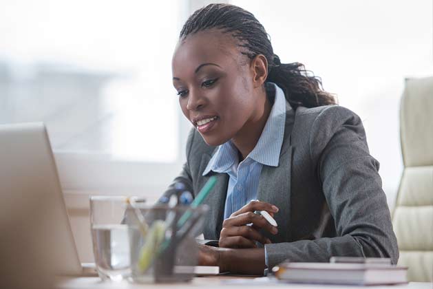 woman with laptop completing online course