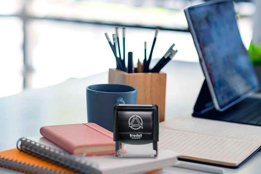 An office desk with Notary seal and journal and a pencil case