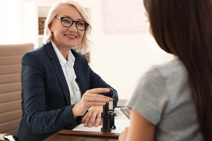 A notary stamps a document for a customer