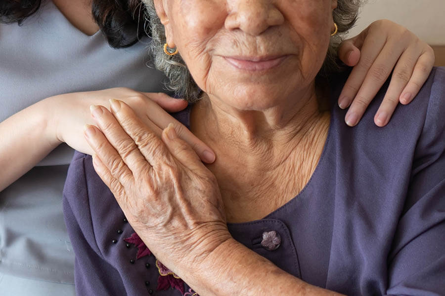 Caregiver offering support to senior woman