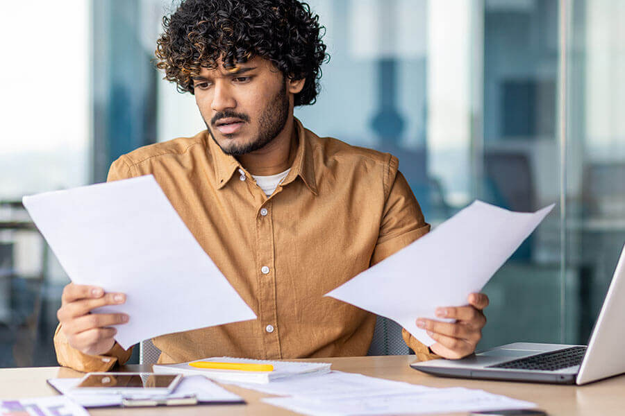 a Notary staring at documents and looking confused