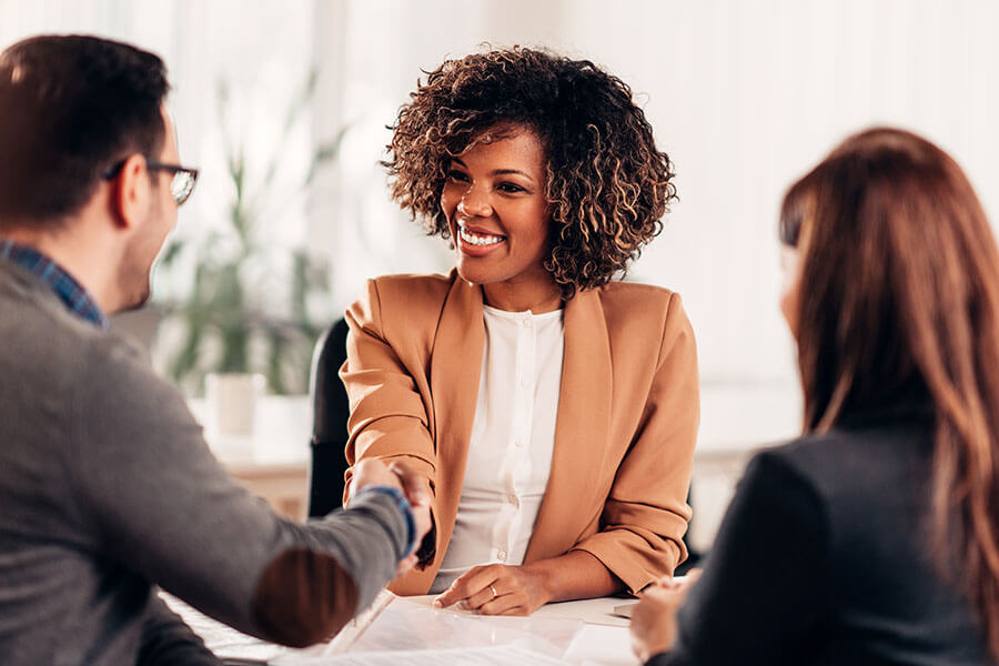 A female Notary and her client are shaking hands.