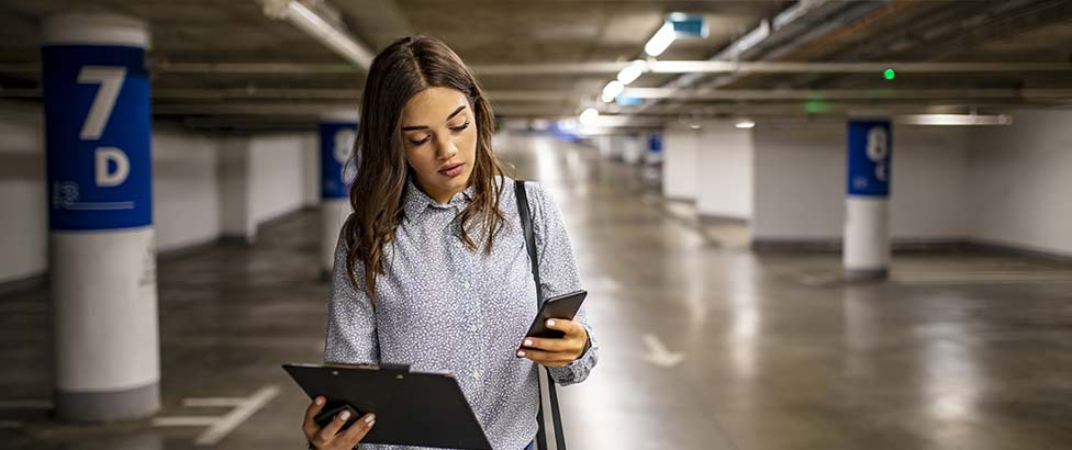 Person holding phone and file holder