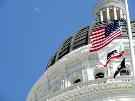 California Capitol building with CA and US flags