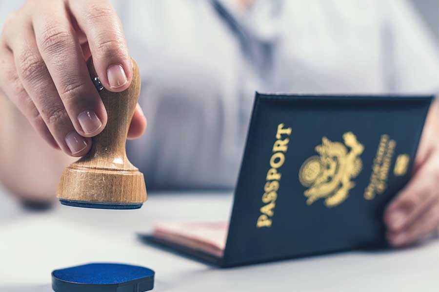 A person holding a stamp and a passport.