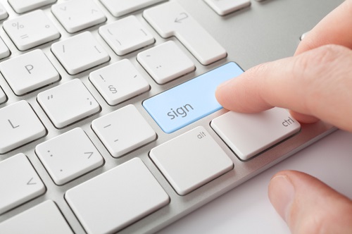 Finger on a keyboard with blue sign button