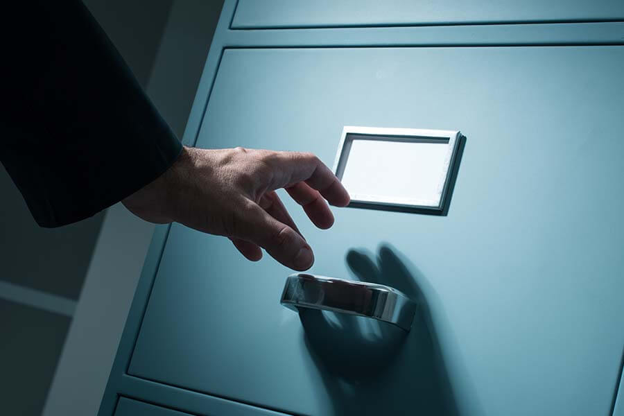 A person attempting to open cabinet door