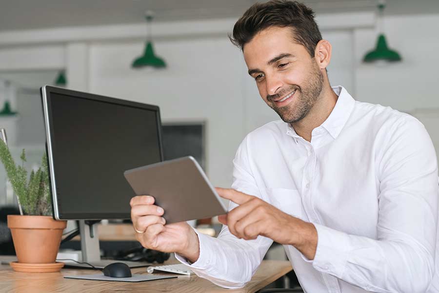 A person happily using iPad