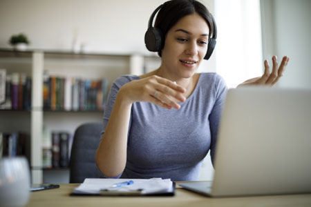 Woman with headphones using a laptop