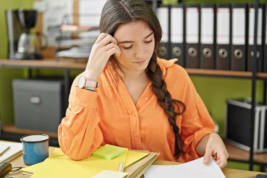 A Notary looking at documents with a concerning face