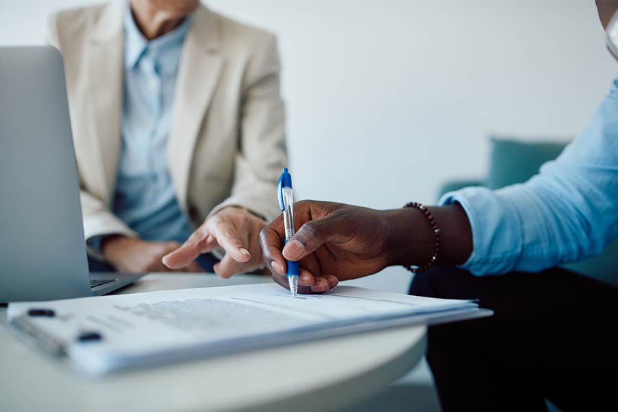 A person signing on a document 