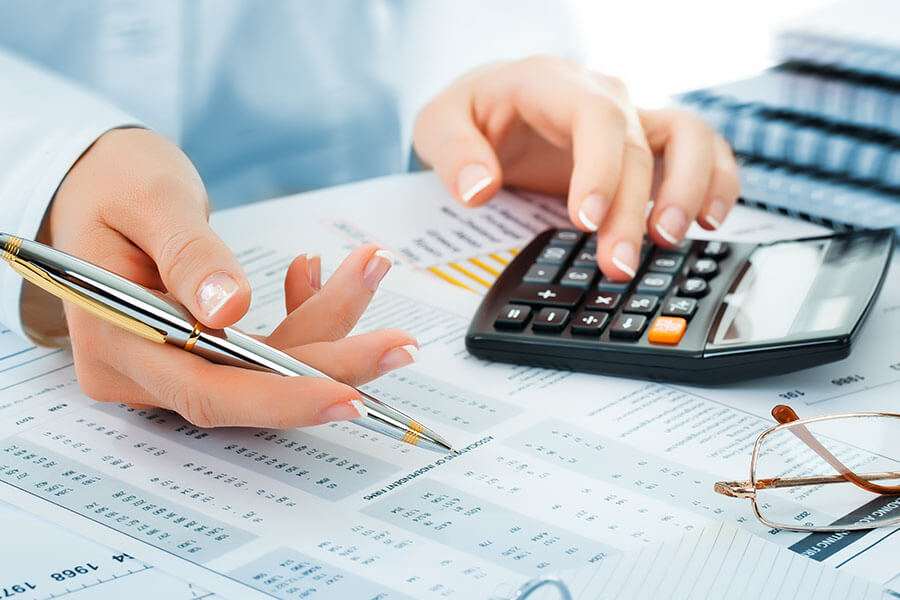 A person using a calculator while reviewing documents