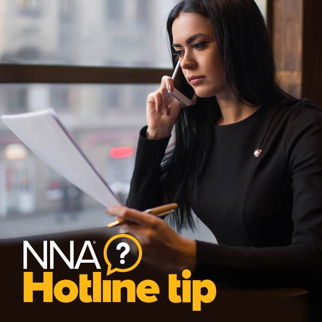 Photo of woman with long dark hair on phone. She is looking at papers in her hand. Text on image reads NNA Hotline Tip.