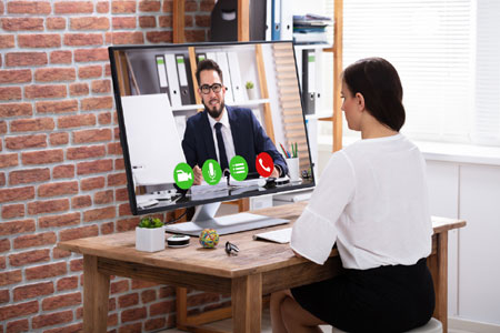 Female Notary performing remote online notarization via computer monitor