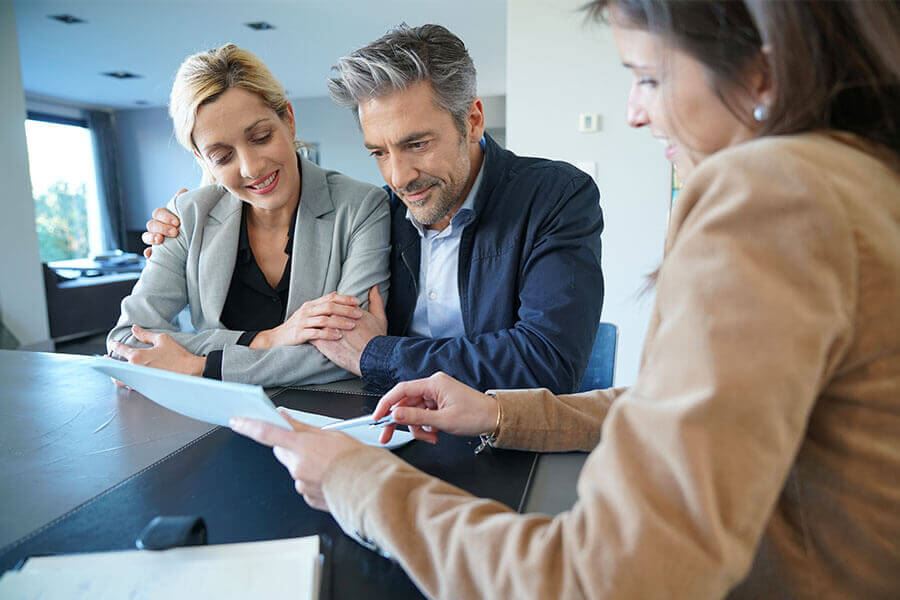 A female Notary interacting with a couple