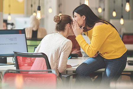 Two individuals engaged in a confidential conversation.