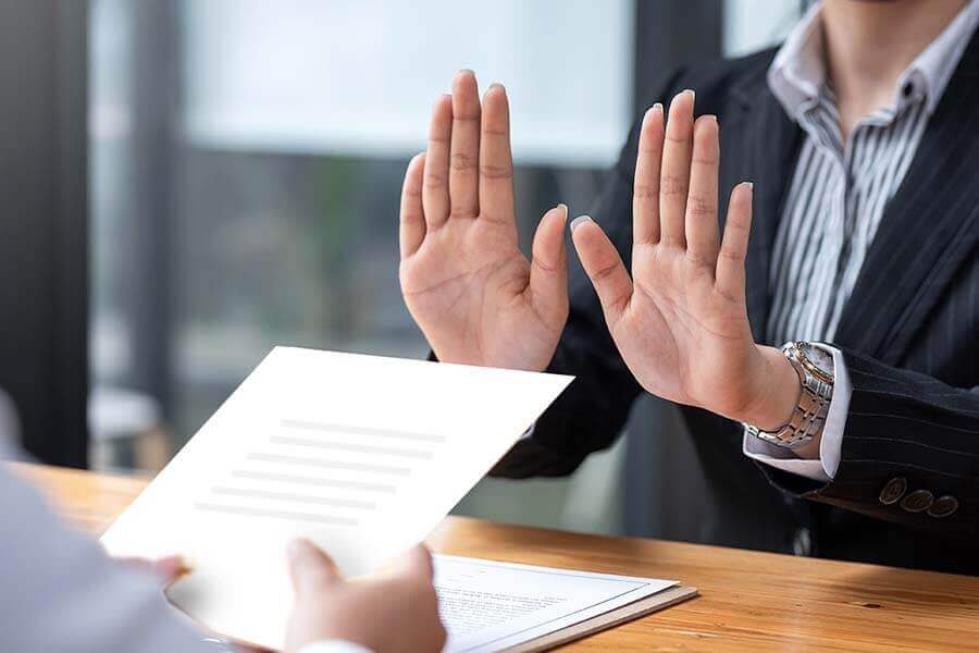 Person with outstretched arms in a 'no' gesture.