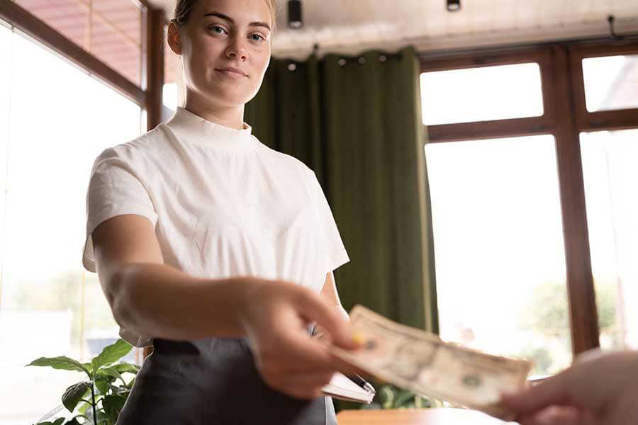 A person being handed money by a customer