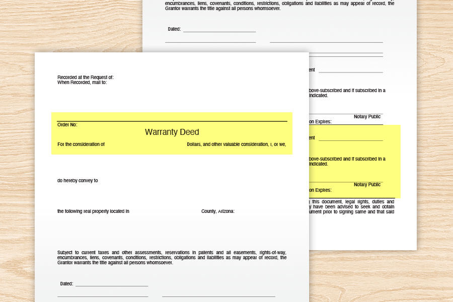 Warranty deed documents on the table