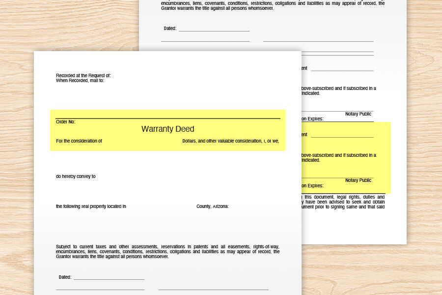 Warranty deed documents on the table