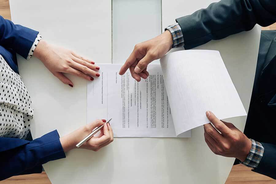 A person signing a document with a Notary