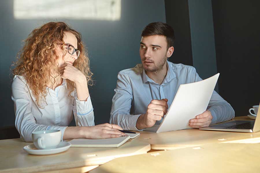 two coworkers in a serious discussion