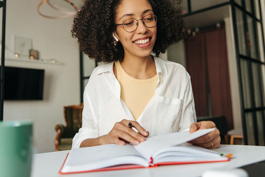 A person journaling with a smiley face