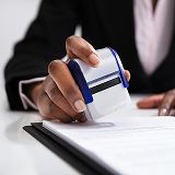A Notary using a Notary stamp