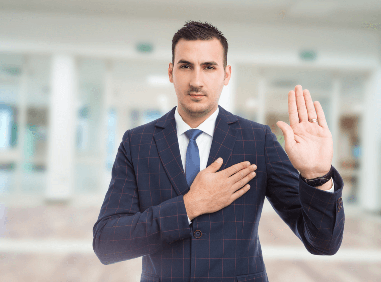 Man in suit taking an oath