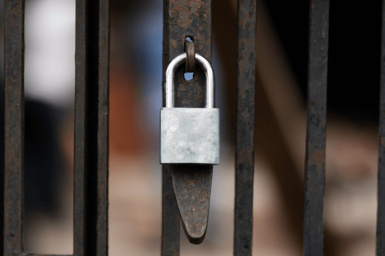 Iron gate with silver padlock