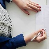 Hands reviewing a printed loan document.