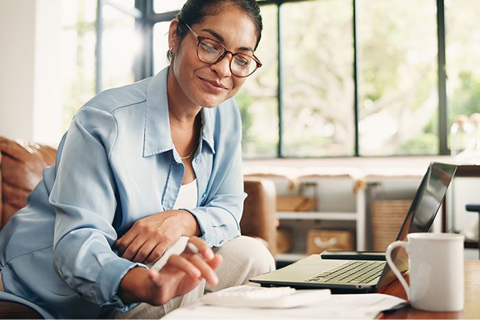 Notary working at a laptop in a bright office.