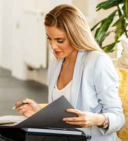 Blonde woman looking down at a folder